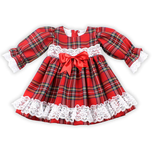 Red plaid dress with white lace trim and a large bow on a white background