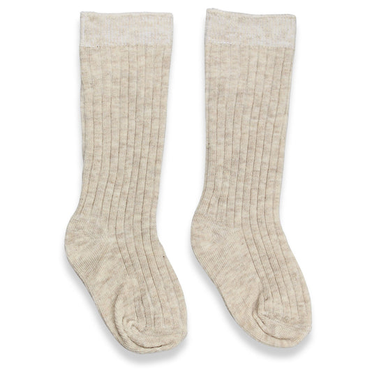 Pair of beige ribbed knee-high socks on a white background