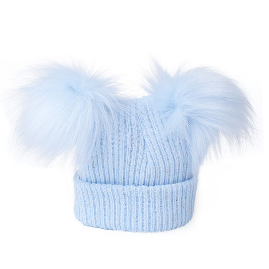 Light blue knit beanie with two large fur pom-poms on a white background