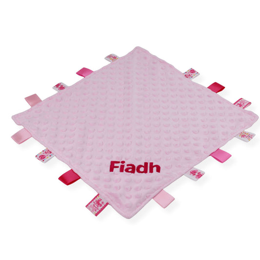 Personalised pink taggy baby comforter with textured fabric and ribbon taggies