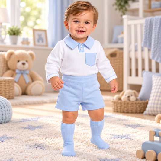 Baby boy wearing blue shorts and white long sleeve polo top two piece outfit
