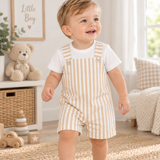 baby boy with dungarees and t shirt with beige and white stripes