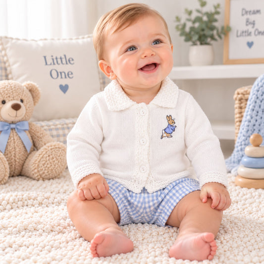 baby boy in white cardigan with rabbit embroidery