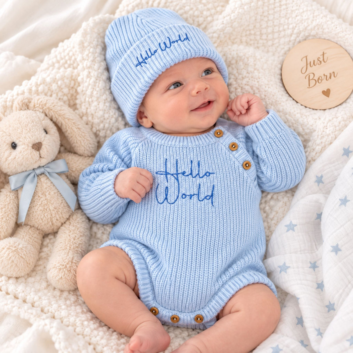 baby boy in blue hello world romper and hat