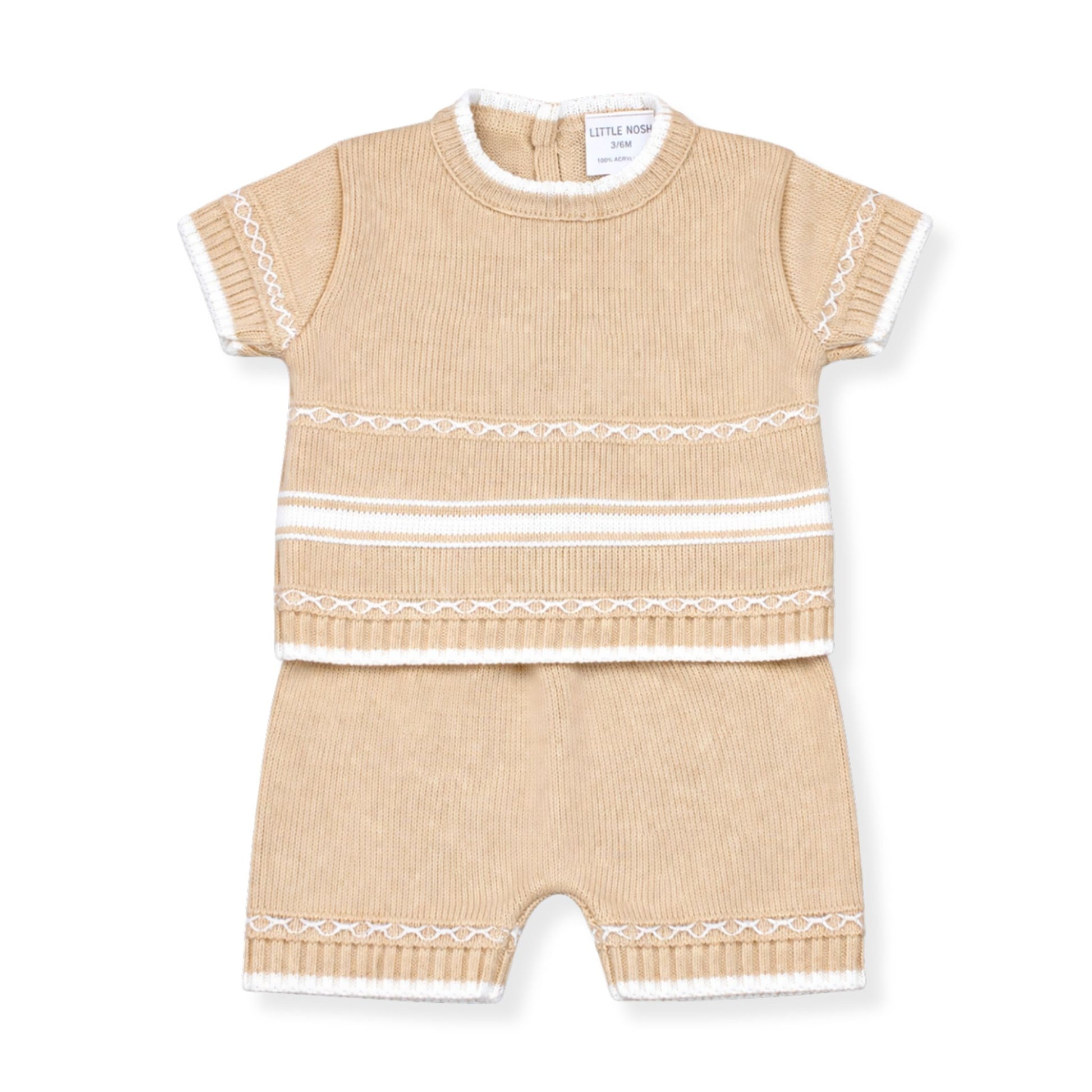 Beige baby romper with white trim on a white background