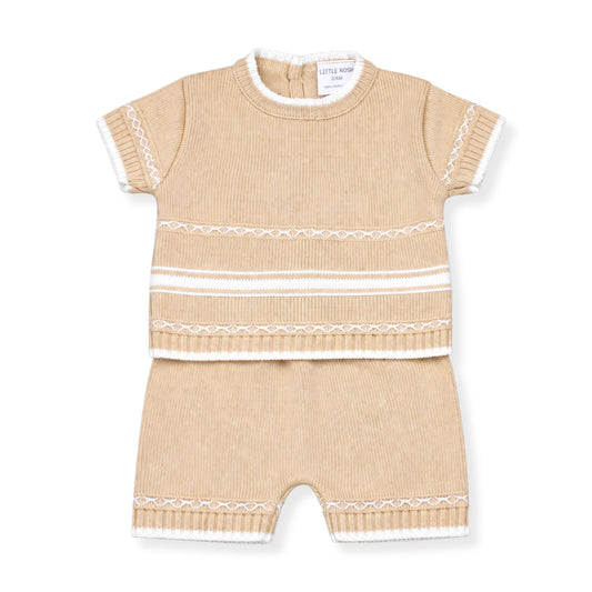Beige baby romper with white trim on a white background