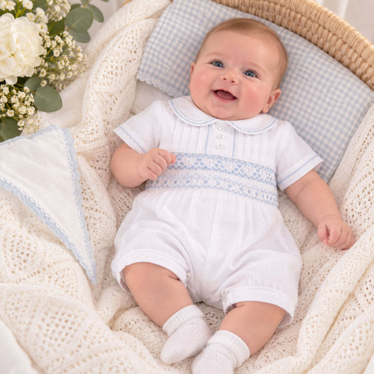 baby boy white blue smcked romper suitable for a christening