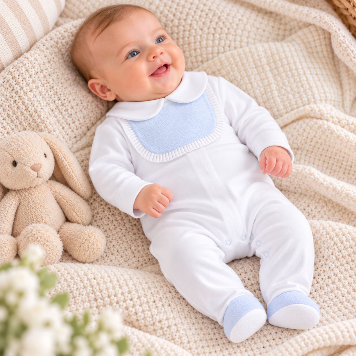 baby boy white cotton sleepsuit with blue bib