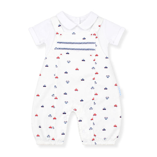 Whiite baby dungarees with car print with a white shirt on a white background