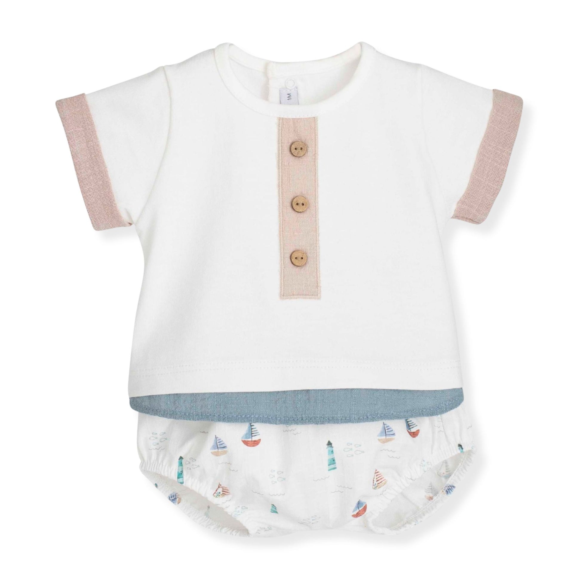 Baby outfit with white top and jam pants set featuring sailboat pattern on a white background
