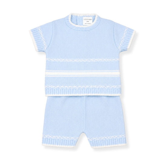Light blue baby outfit with short sleeves and shorts on a white background