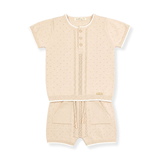 Beige baby outfit with short-sleeve top and shorts on a white background