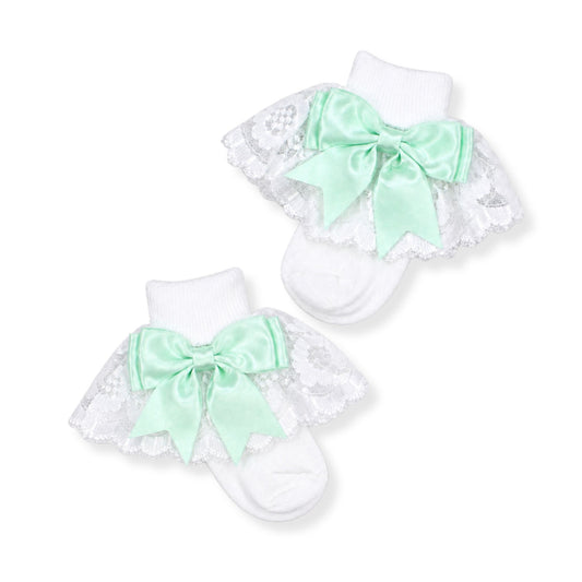 white frilly baby girl socks with mint green bow in a spanish style