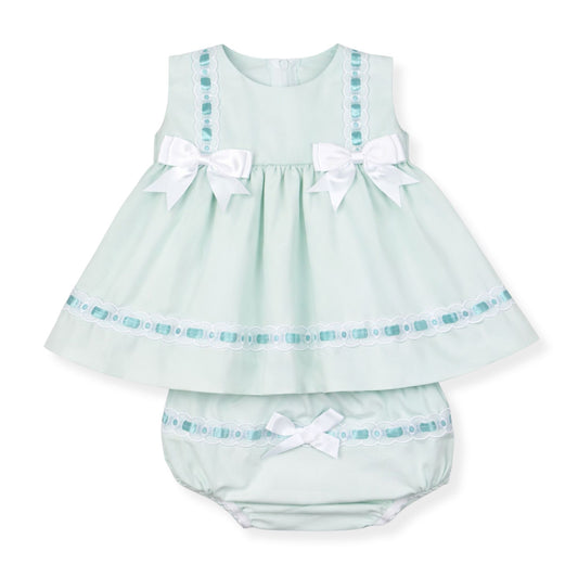 mint green baby dress with white bows and matching bloomers on a white background