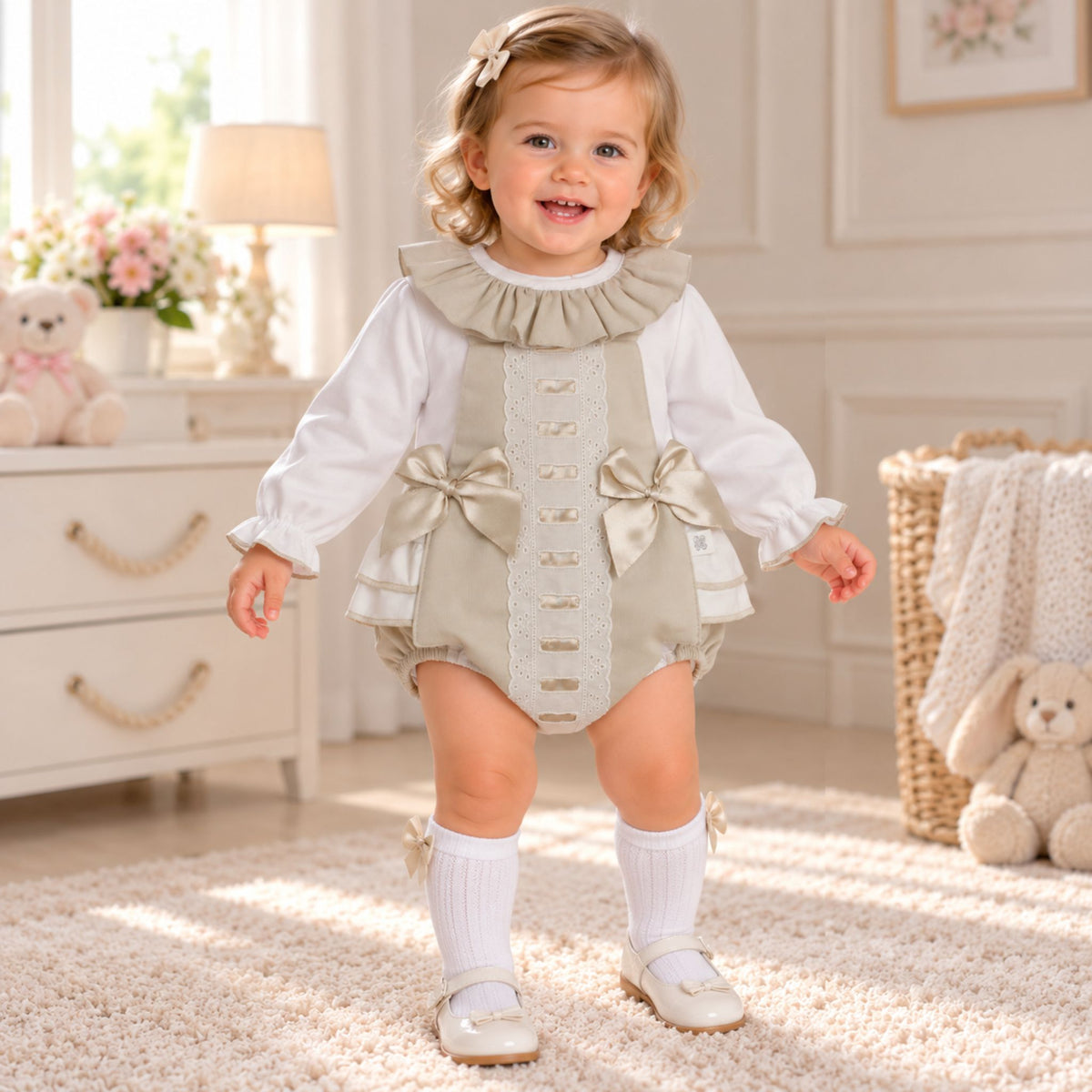 Baby girl wearing beige frill romper and white blouse two piece outfit