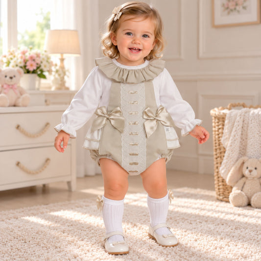 Baby girl wearing beige frill romper and white blouse two piece outfit