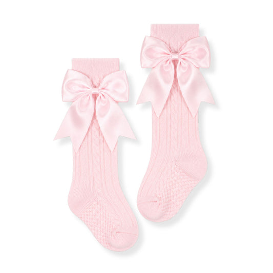 baby girl pink knee high socks with bows in a spanish style