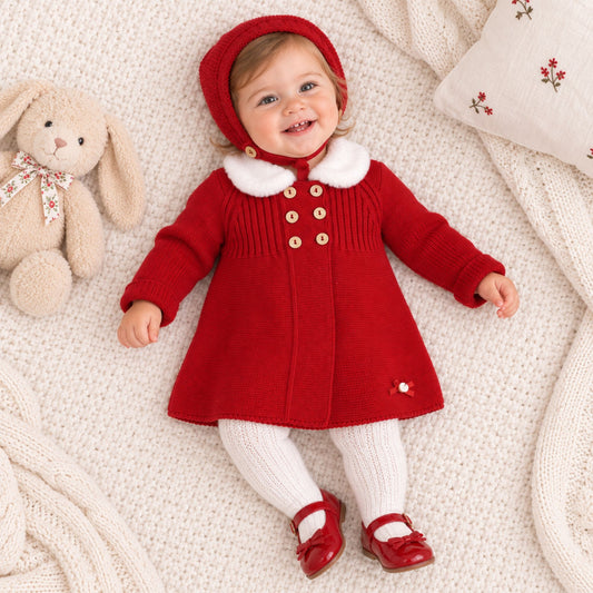 baby girl in red knitted coat with matching red bonnet
