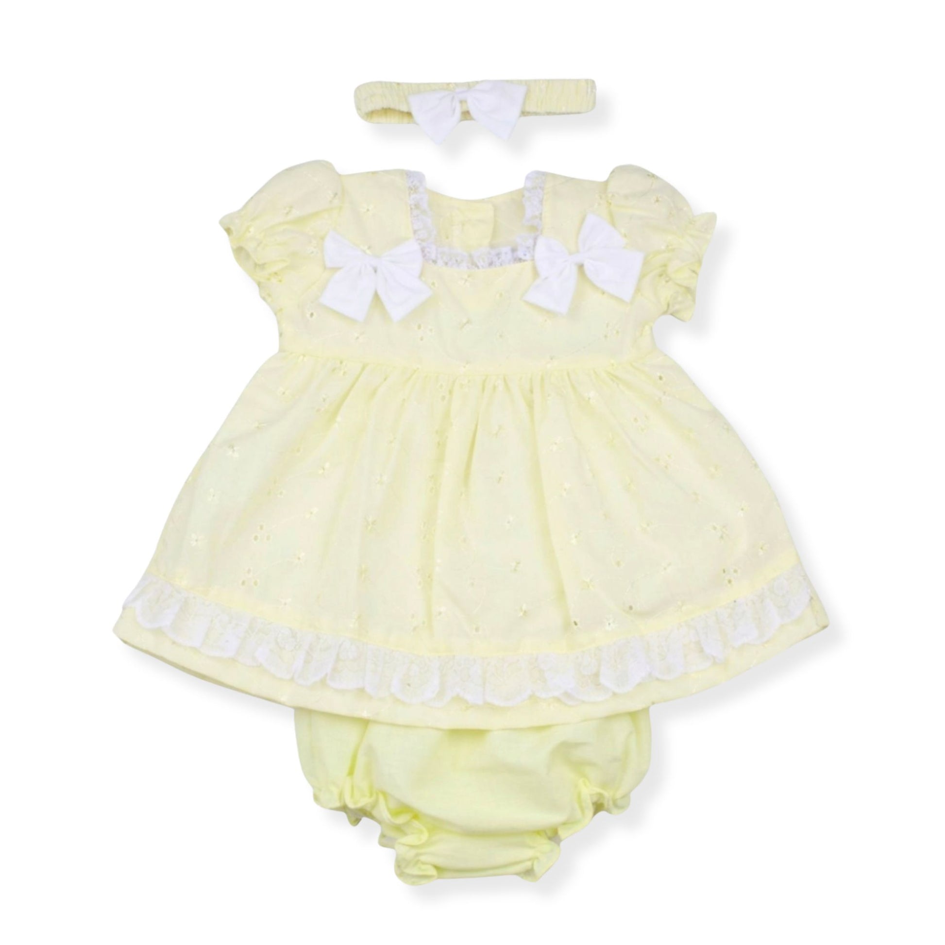 Yellow baby dress with white bows and matching headband on a white background