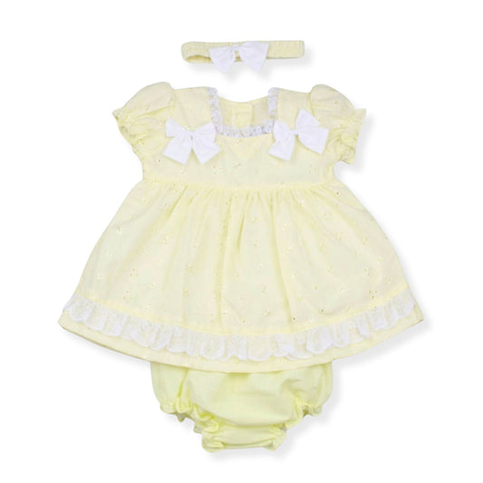 Yellow baby dress with white bows and matching headband on a white background