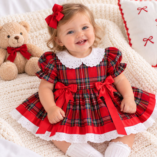 baby girl in christmas dress in red tartan