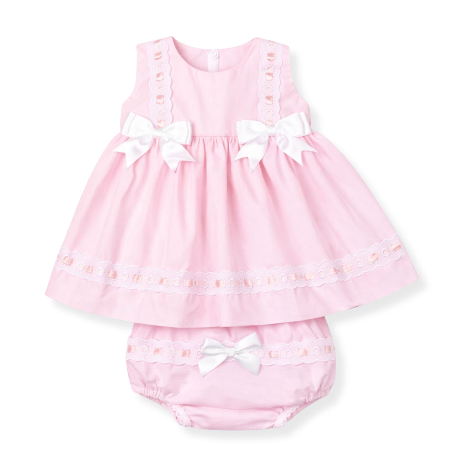 Pink baby dress with white bows on a white background
