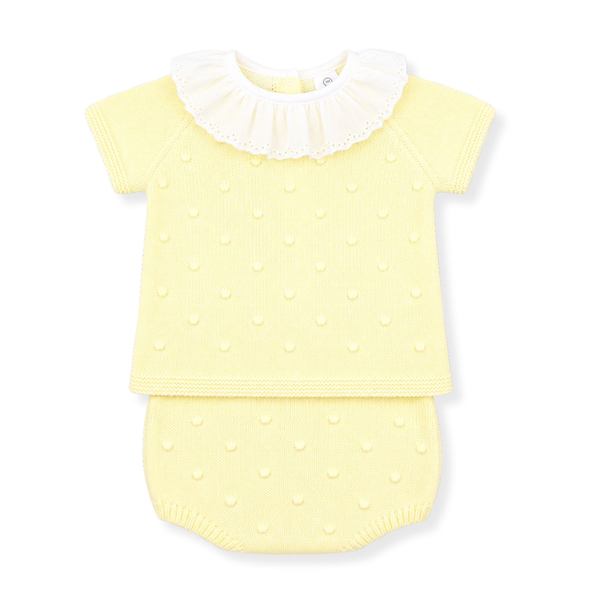 Yellow baby outfit with white collar on a white background