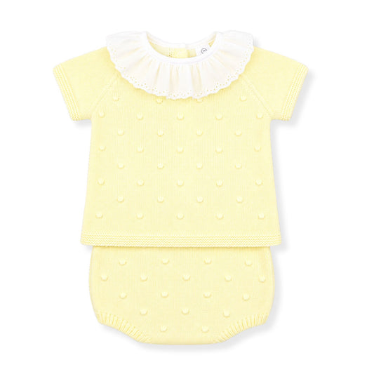 Yellow baby outfit with white collar on a white background