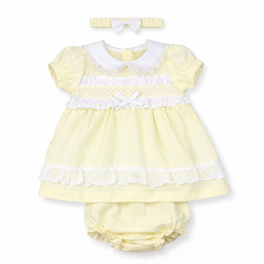Yellow baby dress with white trim, matching headband, and bloomers on a white background