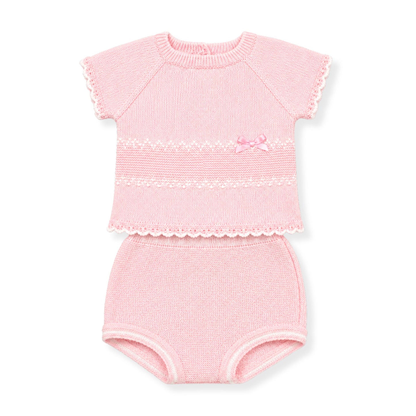 Pink baby outfit with top and knickers on a white