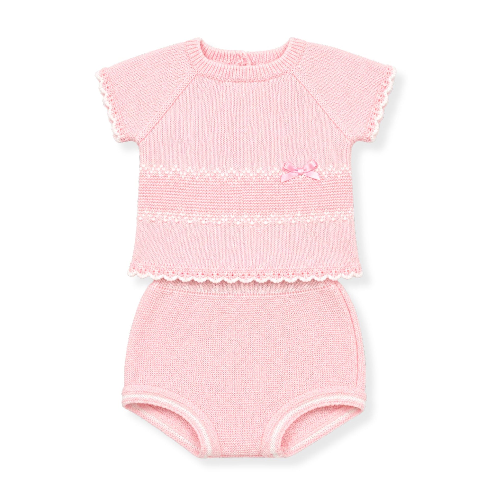 Pink baby outfit with top and knickers on a white