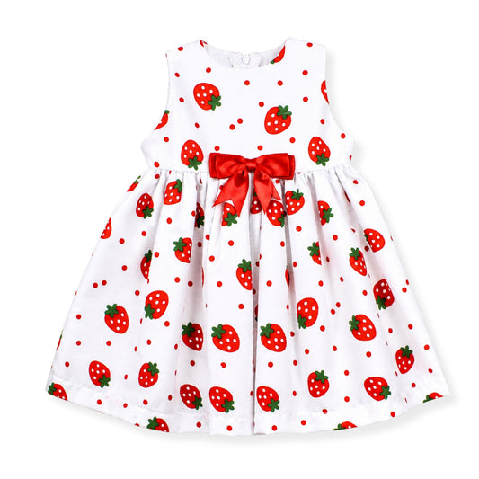 White dress for a baby girl with red strawberry pattern and a red bow on a white background
