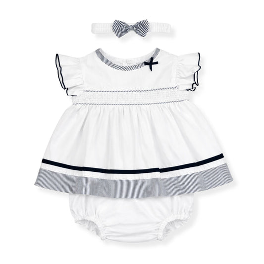 Baby dress with ruffled collar, matching bloomers, and headband on a white background
