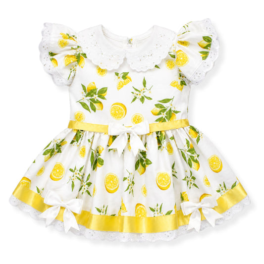 Children's dress with lemon print on a white background
