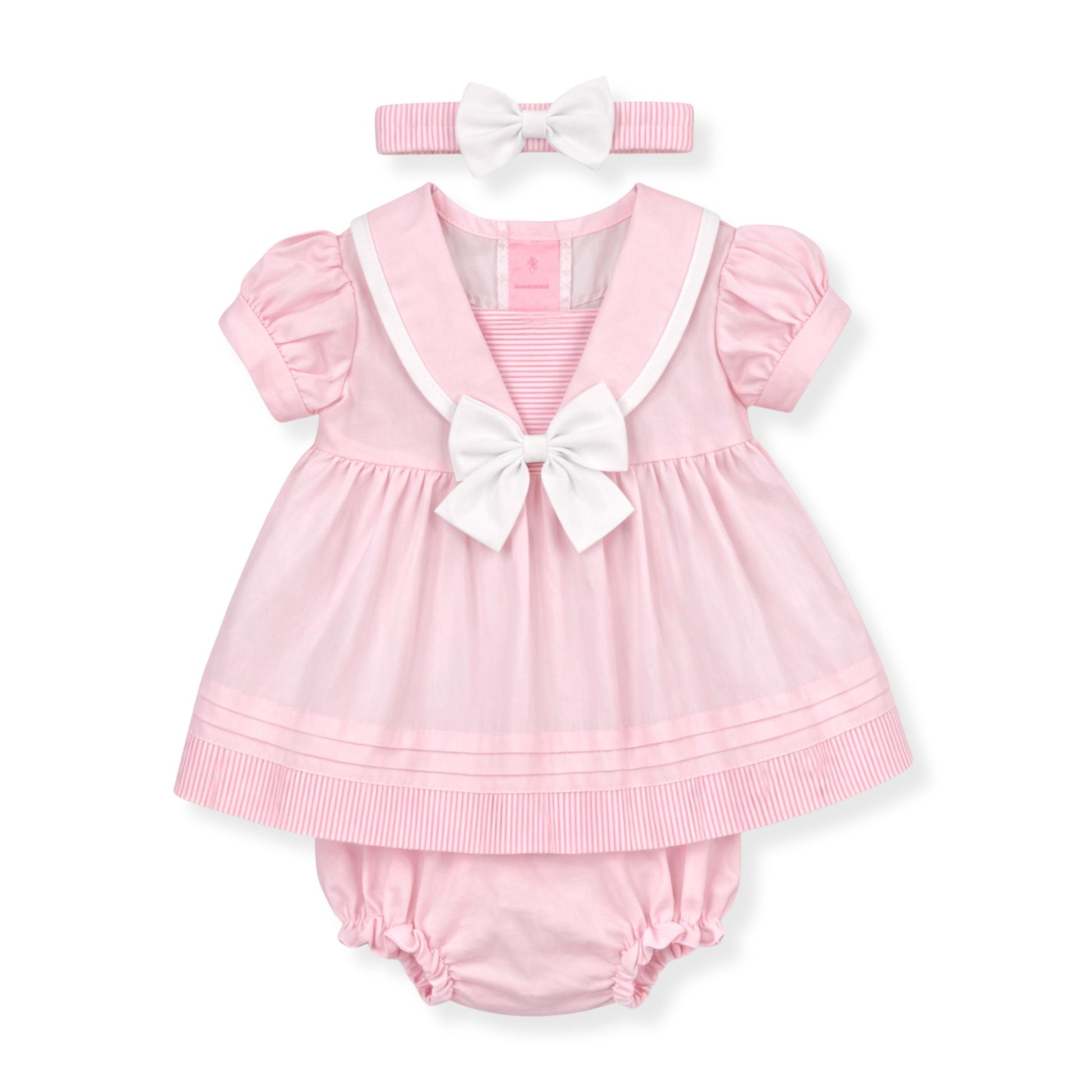 Pink baby outfit with a dress and bloomers on a white background