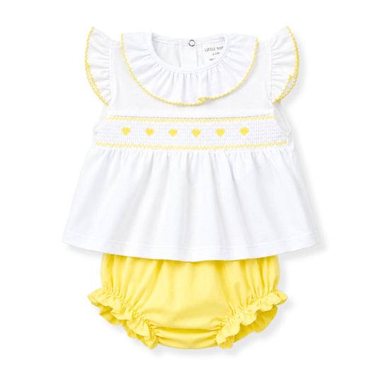 White top with yellow trim and yellow bloomers on a white background