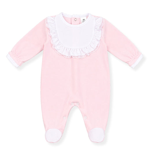 Pink baby girls’ babygrow with white bib front, frill and lace trim detail, long sleeves and footed design, photographed on a clean white background