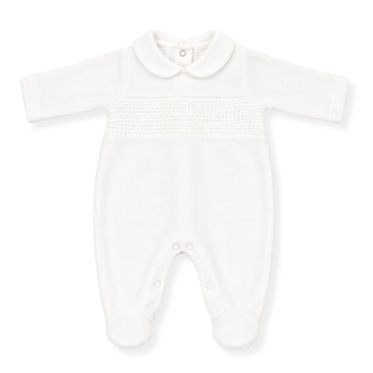 White baby unisex babygrow with Peter Pan collar and smocked chest detail, long sleeves and footed design on a clean white background