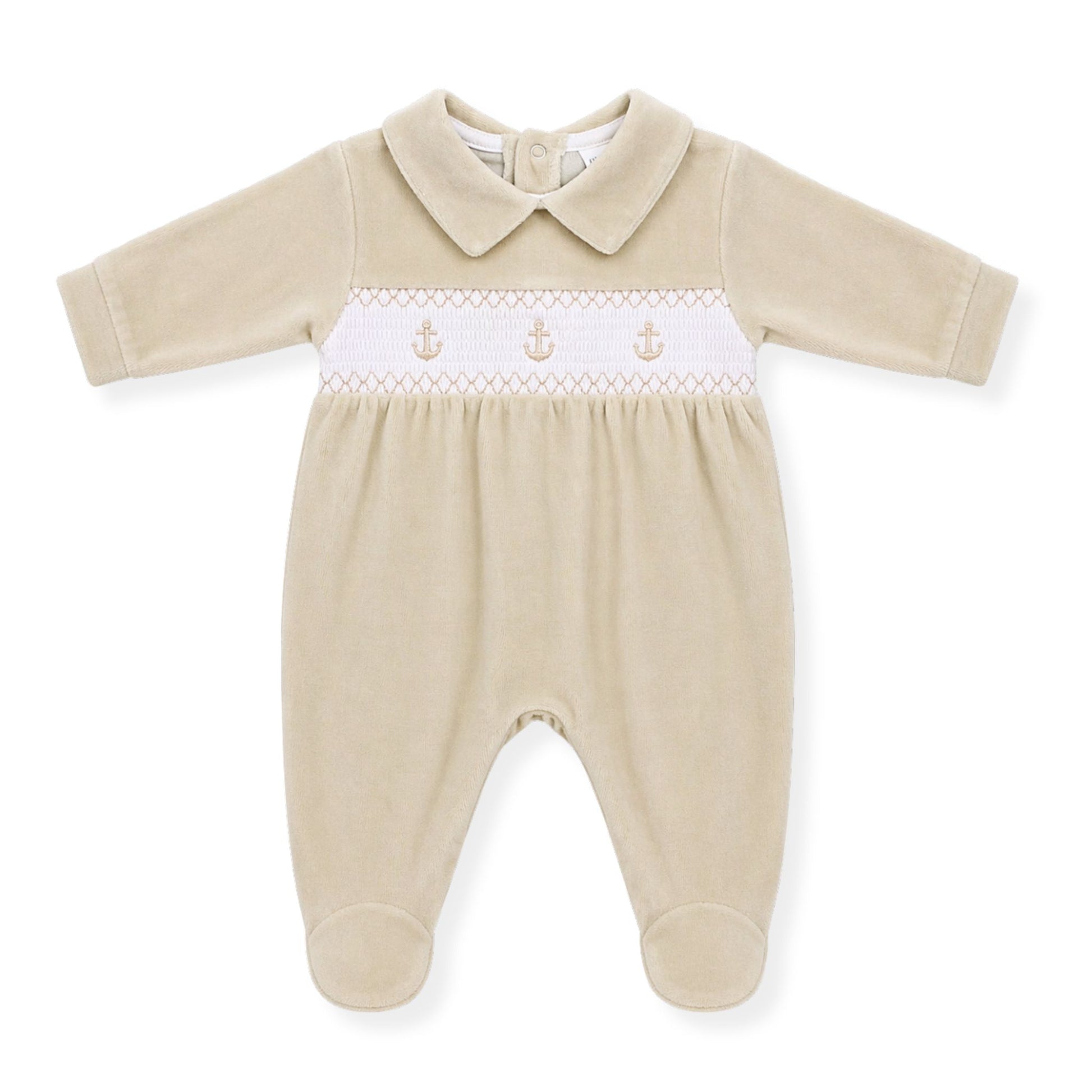 Beige baby boys babygrow with white smocked panel and anchor embroidery on a white background