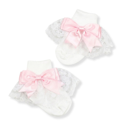 baby girls white frilly fancy socks ith a pink bow in a spanish style