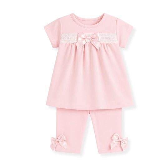 Pink baby outfit with a top and leggings on a white background