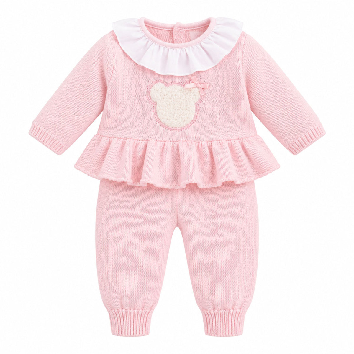 A baby girl's two-piece knit outfit in light pink, featuring a long-sleeve top with a white ruffled collar and a beige teddy bear applique on the chest, paired with matching ribbed knit pants with cuffed ankles.