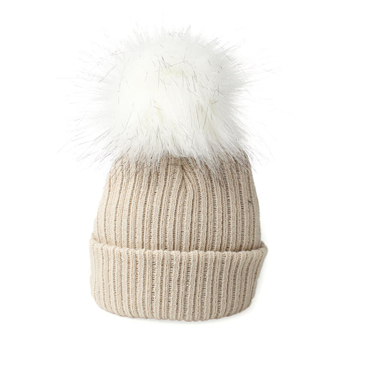 Beige knit beanie with a white faux fur pom-pom on a white background