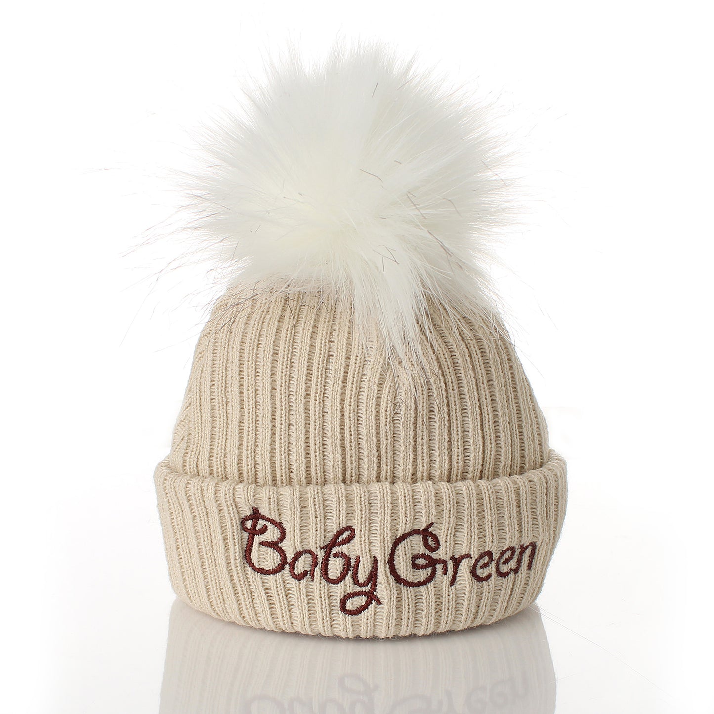 Beige knit beanie with white pom-pom and embroidered name 'Cillian' on a white background