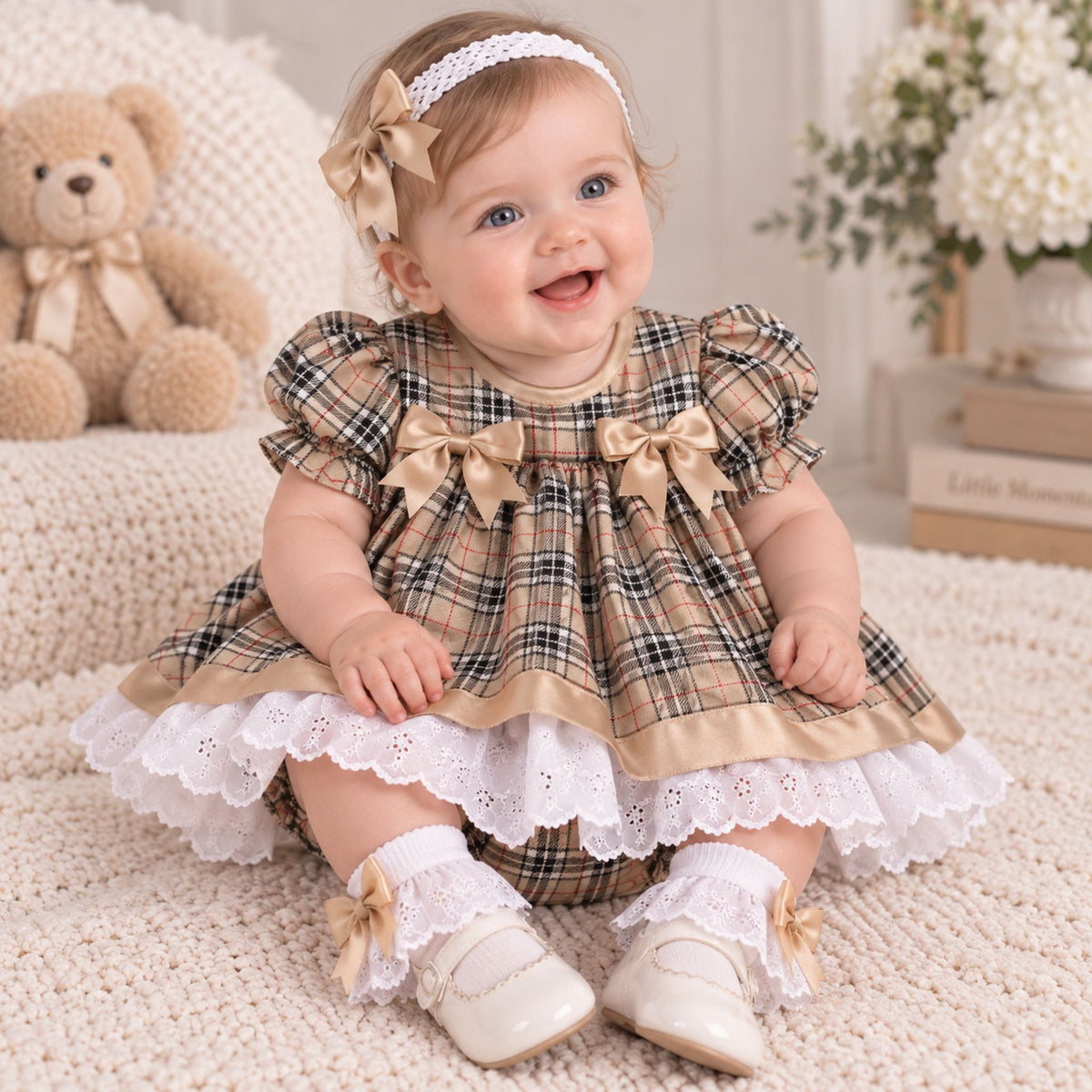 baby girl in beige tartan outfit