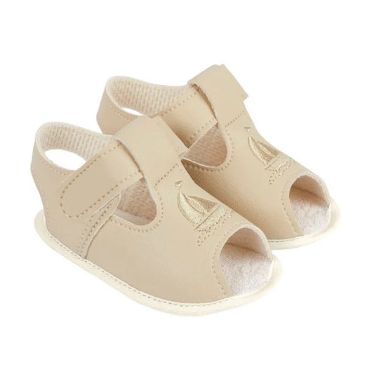 Beige baby sandals on a white background