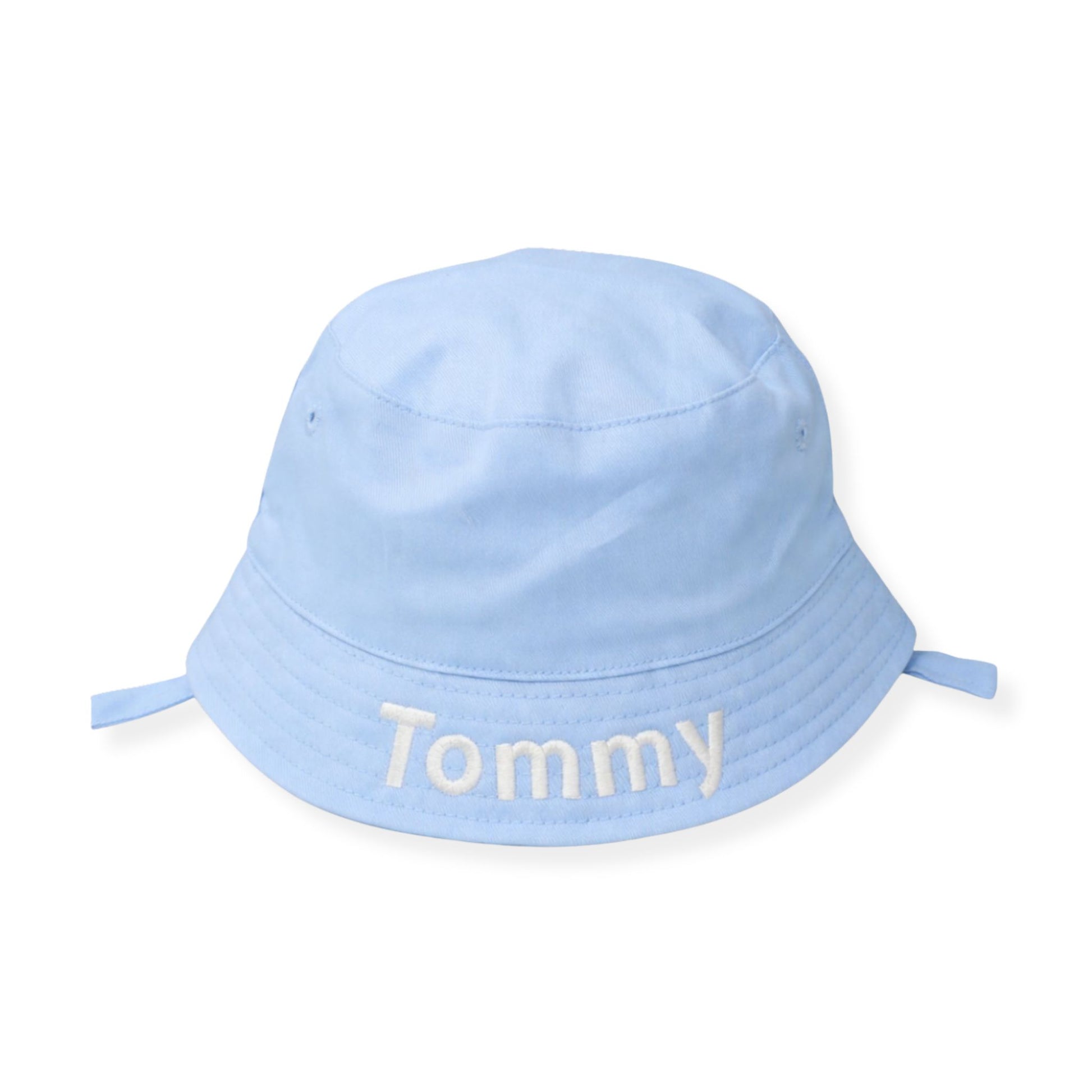 Light blue bucket hat with 'Tommy' embroidered on a white background
