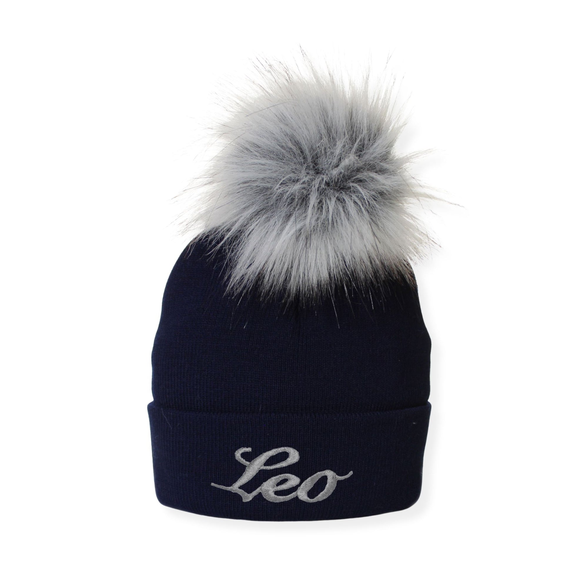 Navy blue beanie with gray fur pom-pom and 'Leo' embroidery on a white background