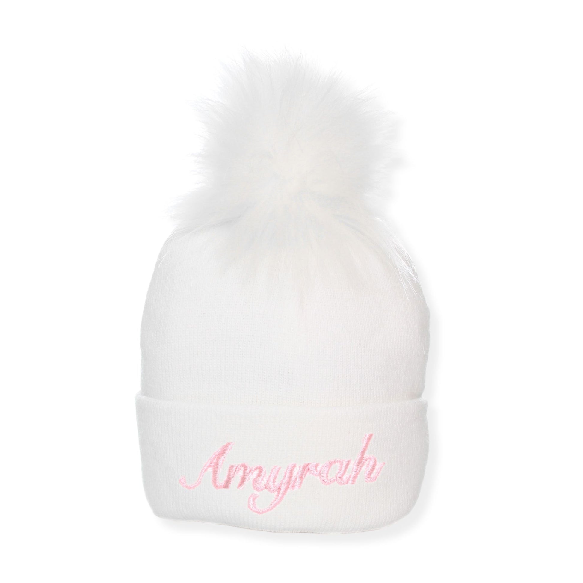 White beanie with pink embroidered text on a white background