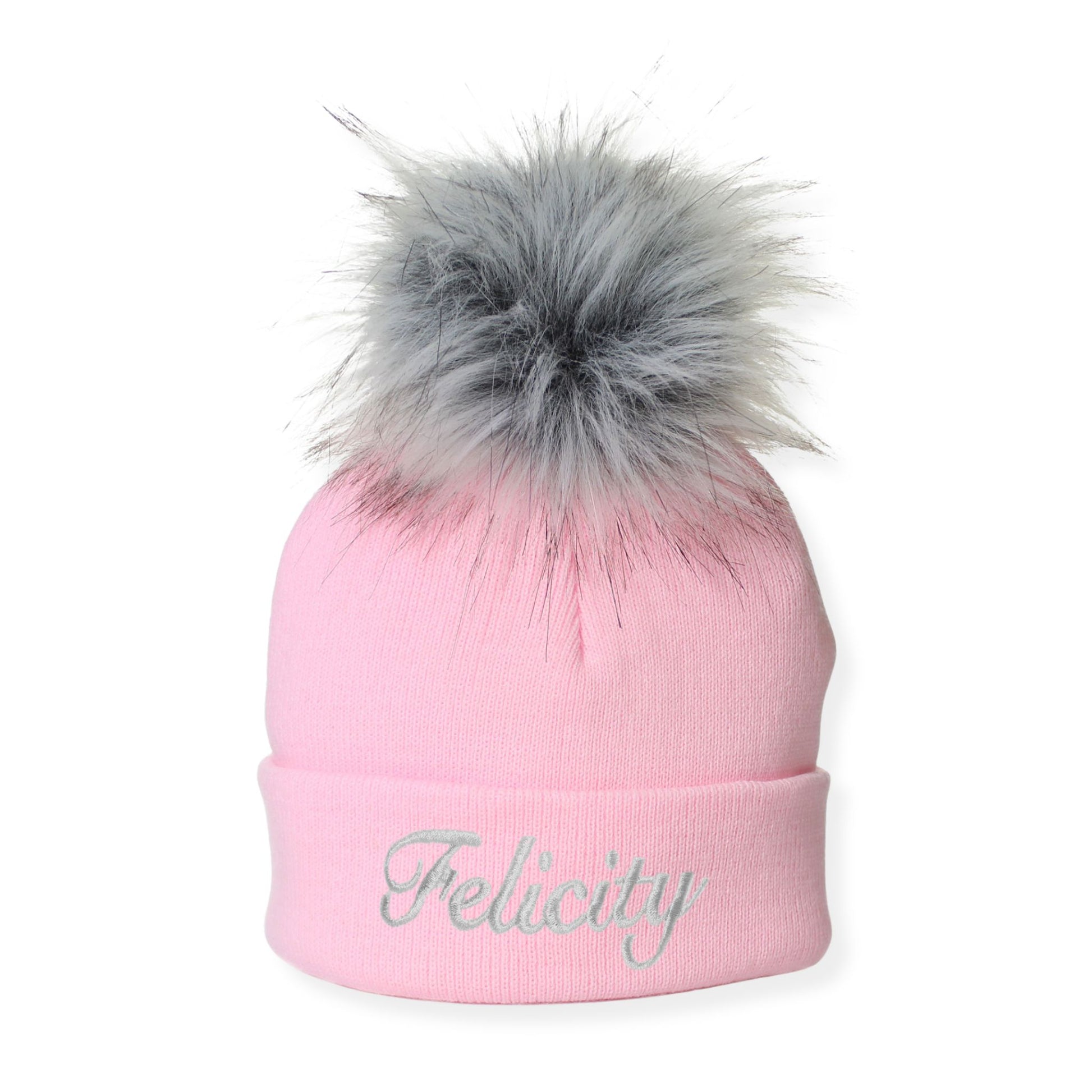 Pink beanie with gray fur pom-pom and 'Felicity' embroidery on a white background